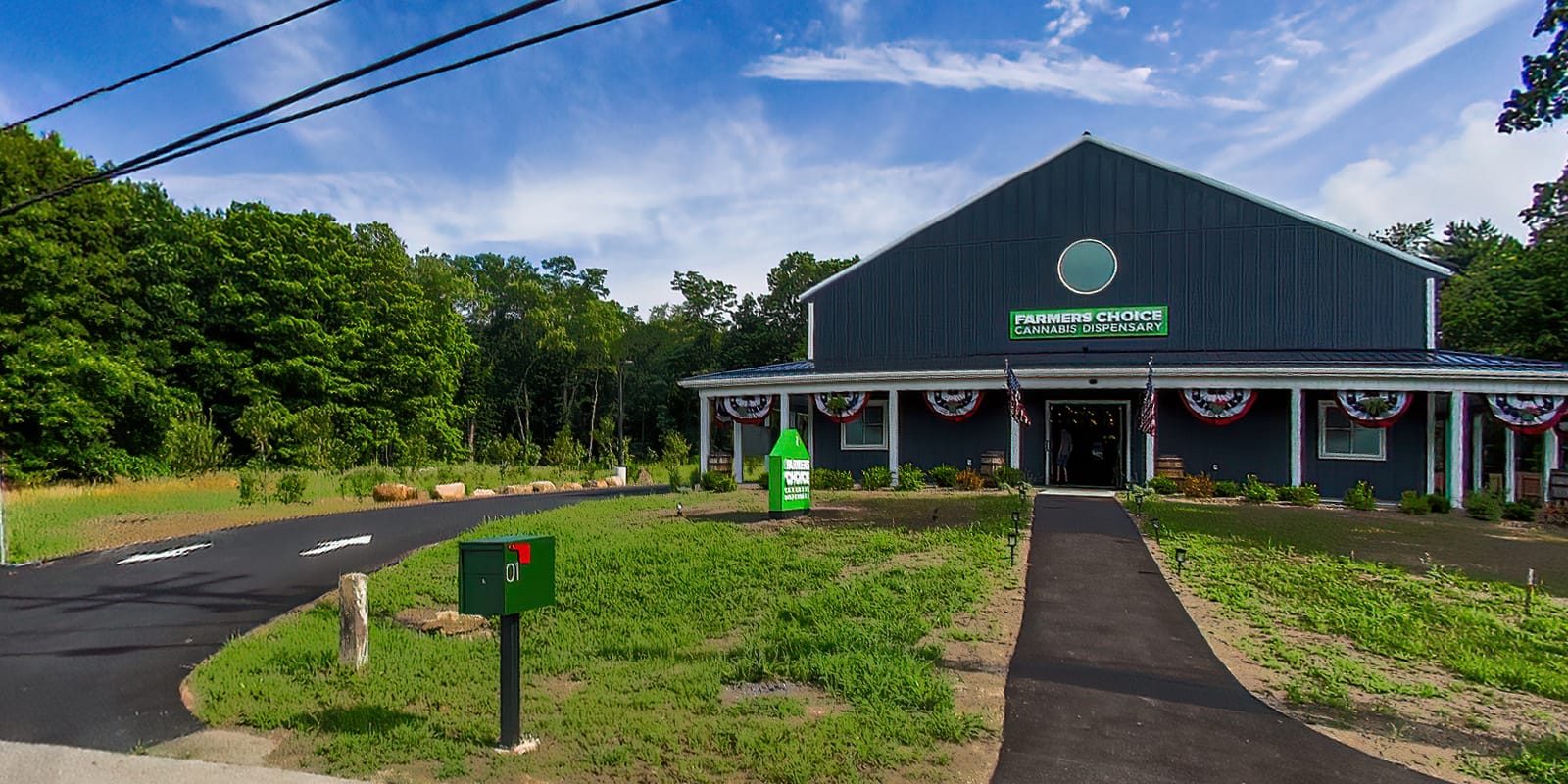 Farmers Choice dispensary building with driveway and green sign
